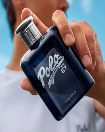 Hand holding a Designer Fragrance bottle of Ralph Lauren Polo 67 EDT. Men's Designer Fragrance category banner.