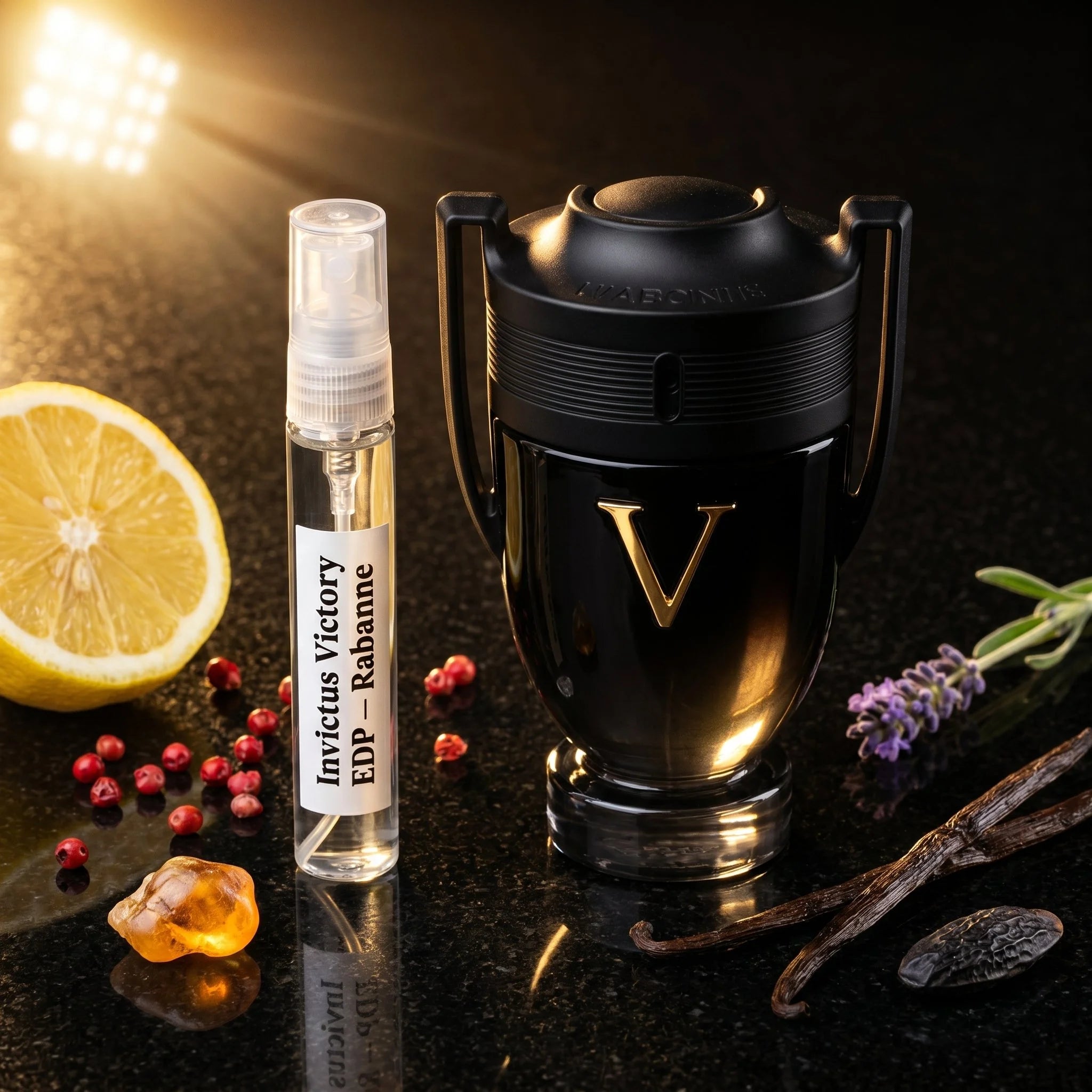 Rabanne Invictus Victory EDP bottle and decant on black granite with lemon pink pepper olibanum lavender vanilla tonka amber fragrance notes flatlay