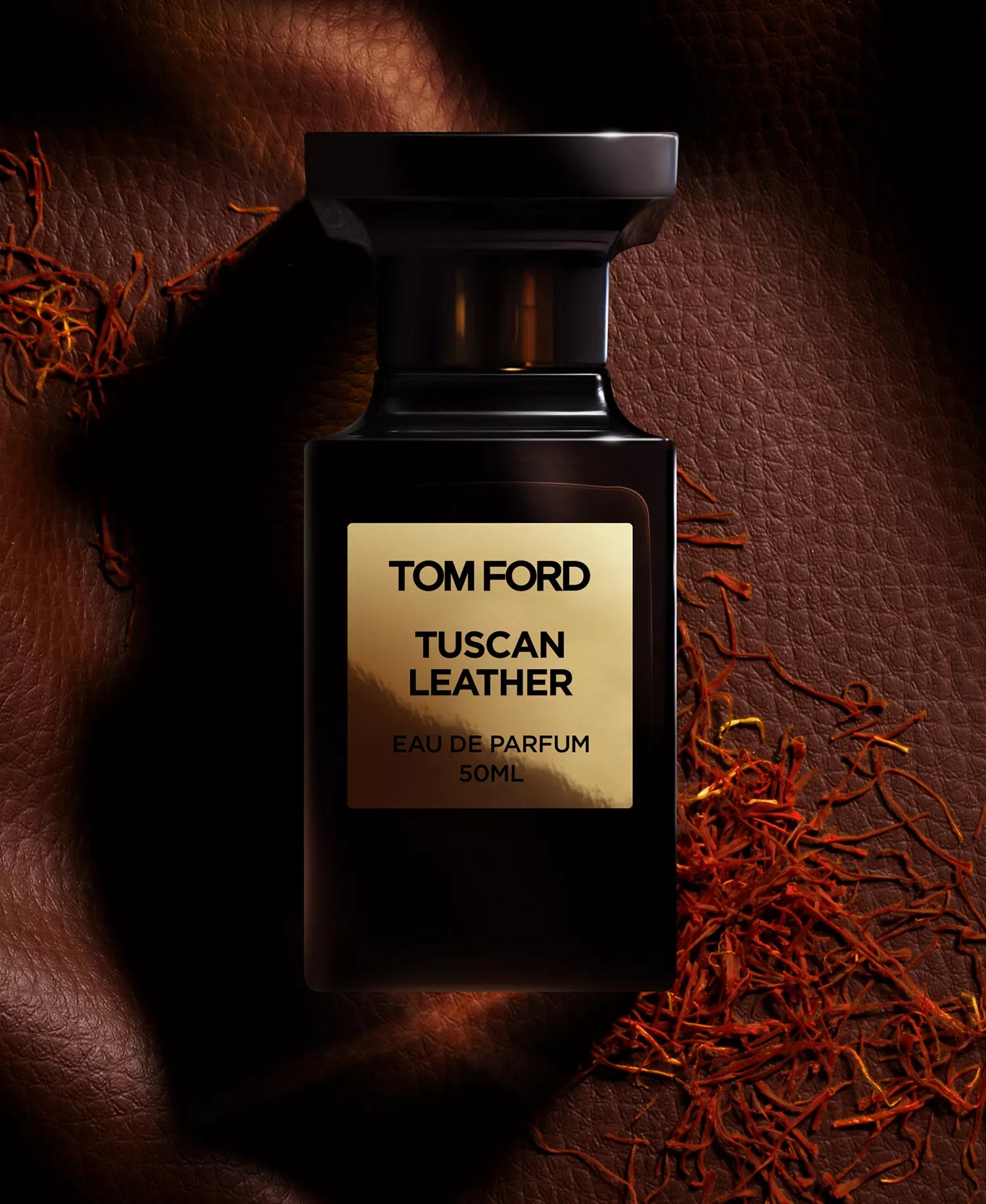 Tom Ford Tuscan Leather perfume bottle on a textured brown background