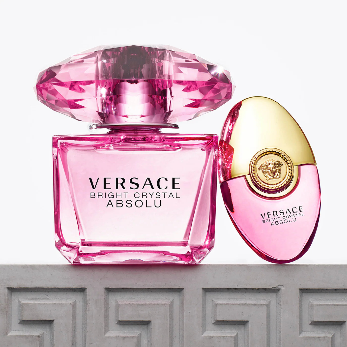 Versace Bright Crystal Absolu perfume set featuring full-size EDP with faceted pink crystal cap and travel rollerball