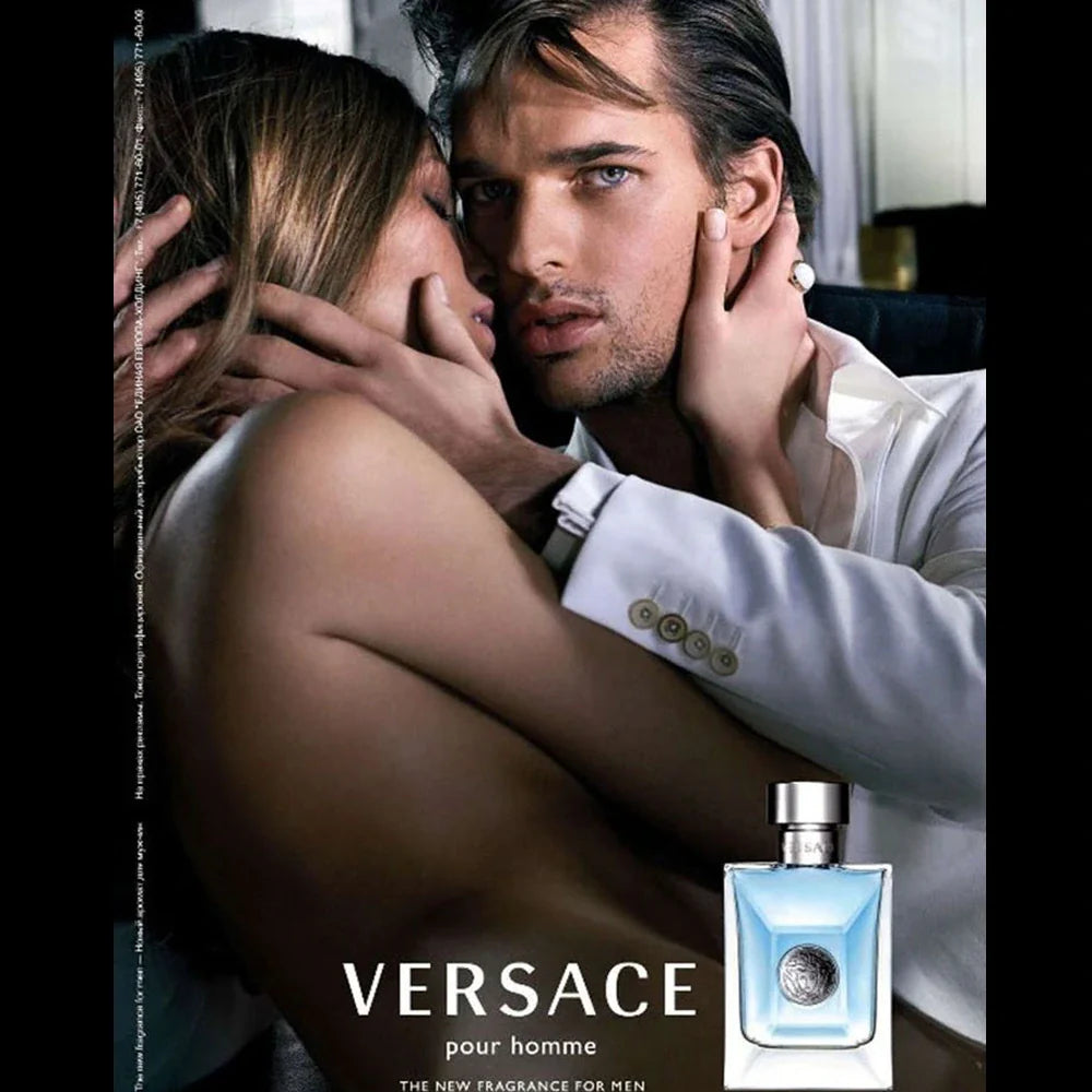 Advertisement for Versace pour homme featuring a man and woman embracing with a bottle of Versace cologne.