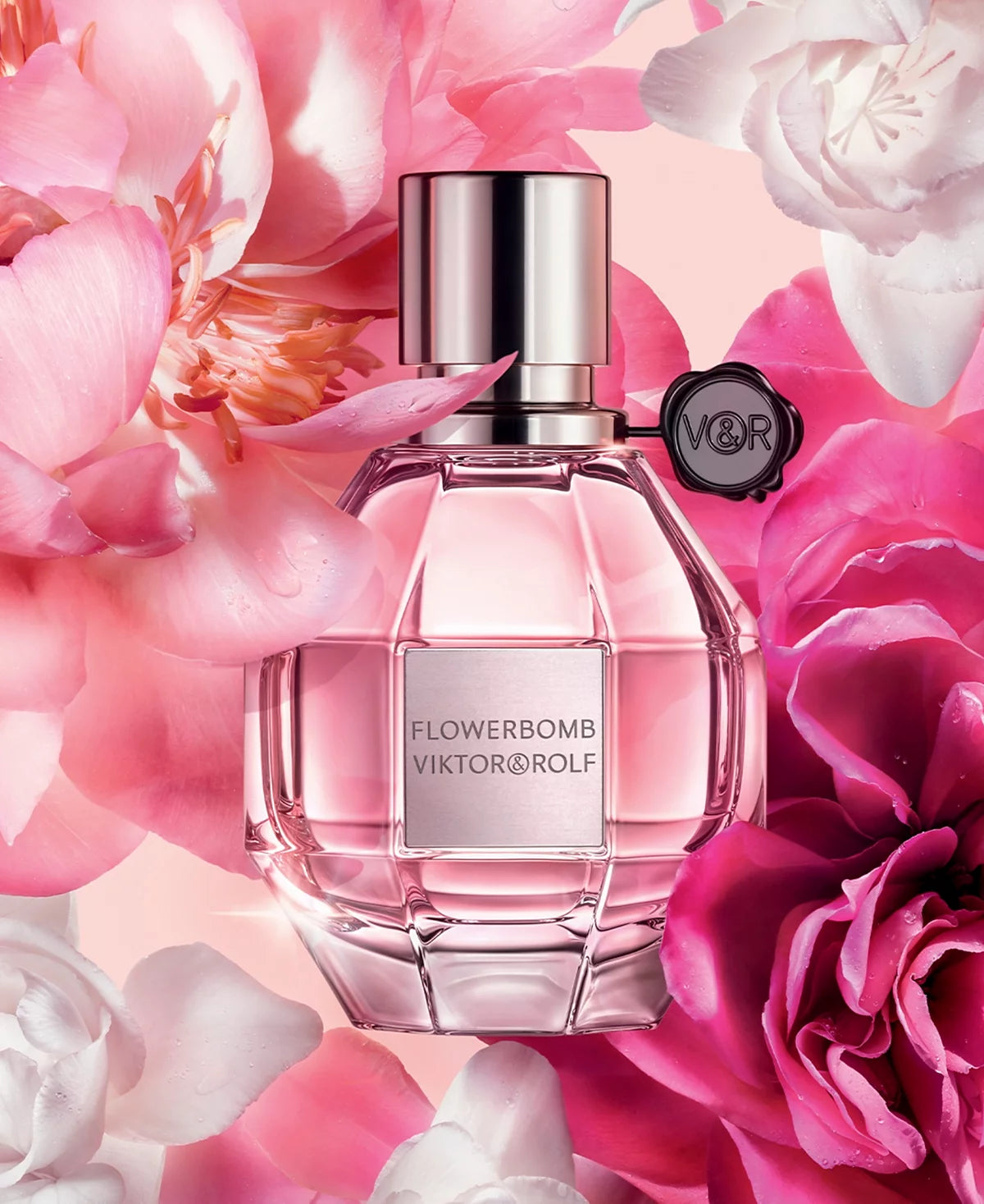 Viktor & Rolf Flowerbomb perfume bottle with pink flowers in the background