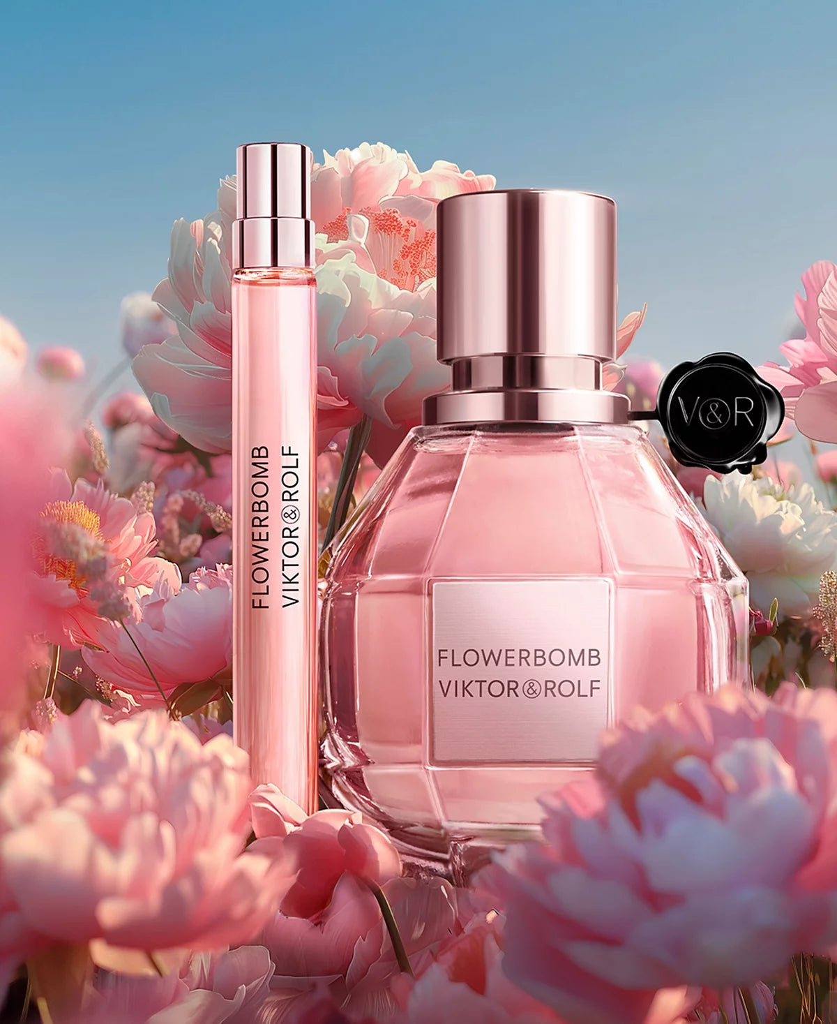 Viktor & Rolf Flowerbomb perfume bottle with smaller bottle and flowers in the background