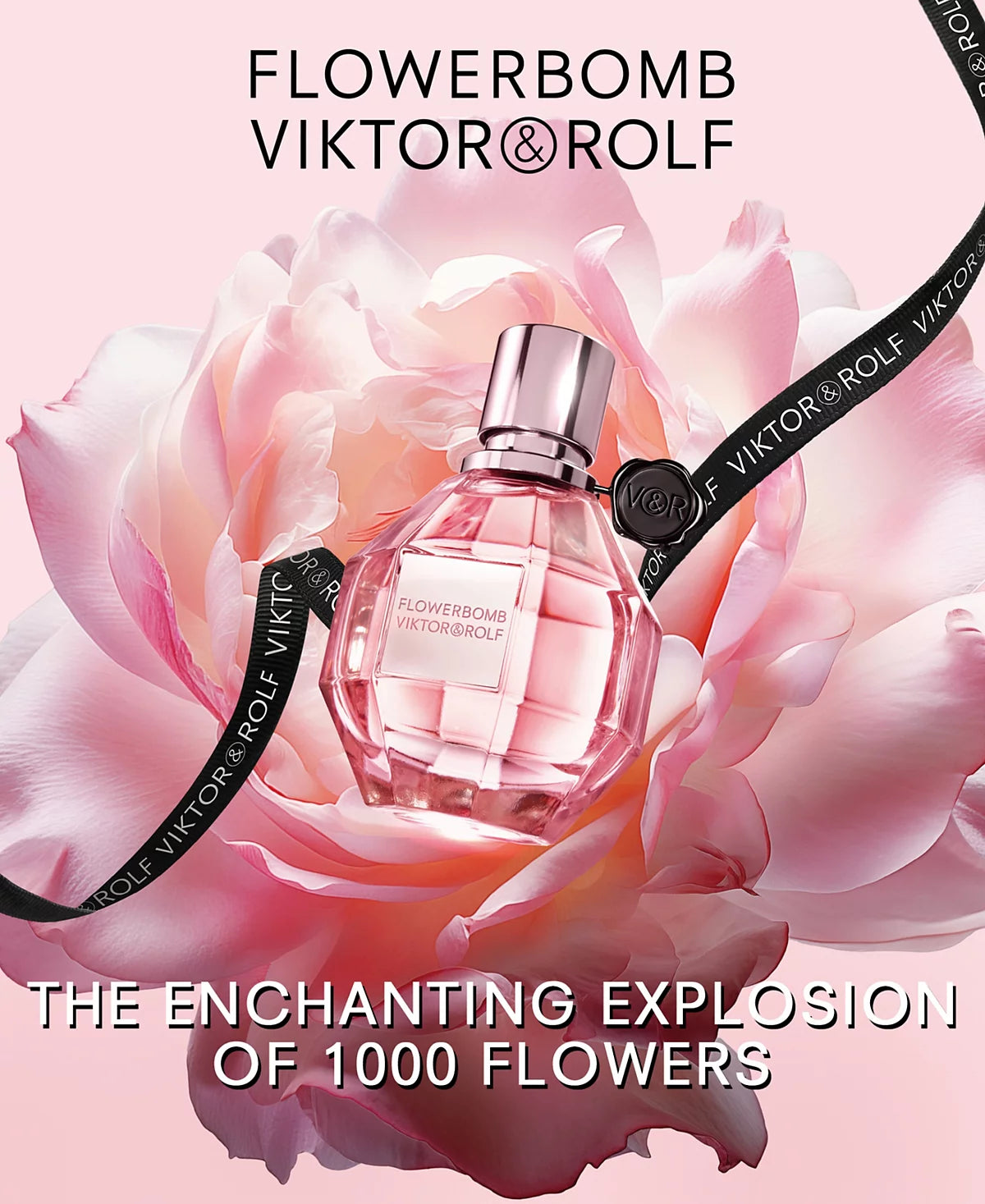 Viktor & Rolf Flowerbomb perfume bottle surrounded by pink flowers on a light pink background.