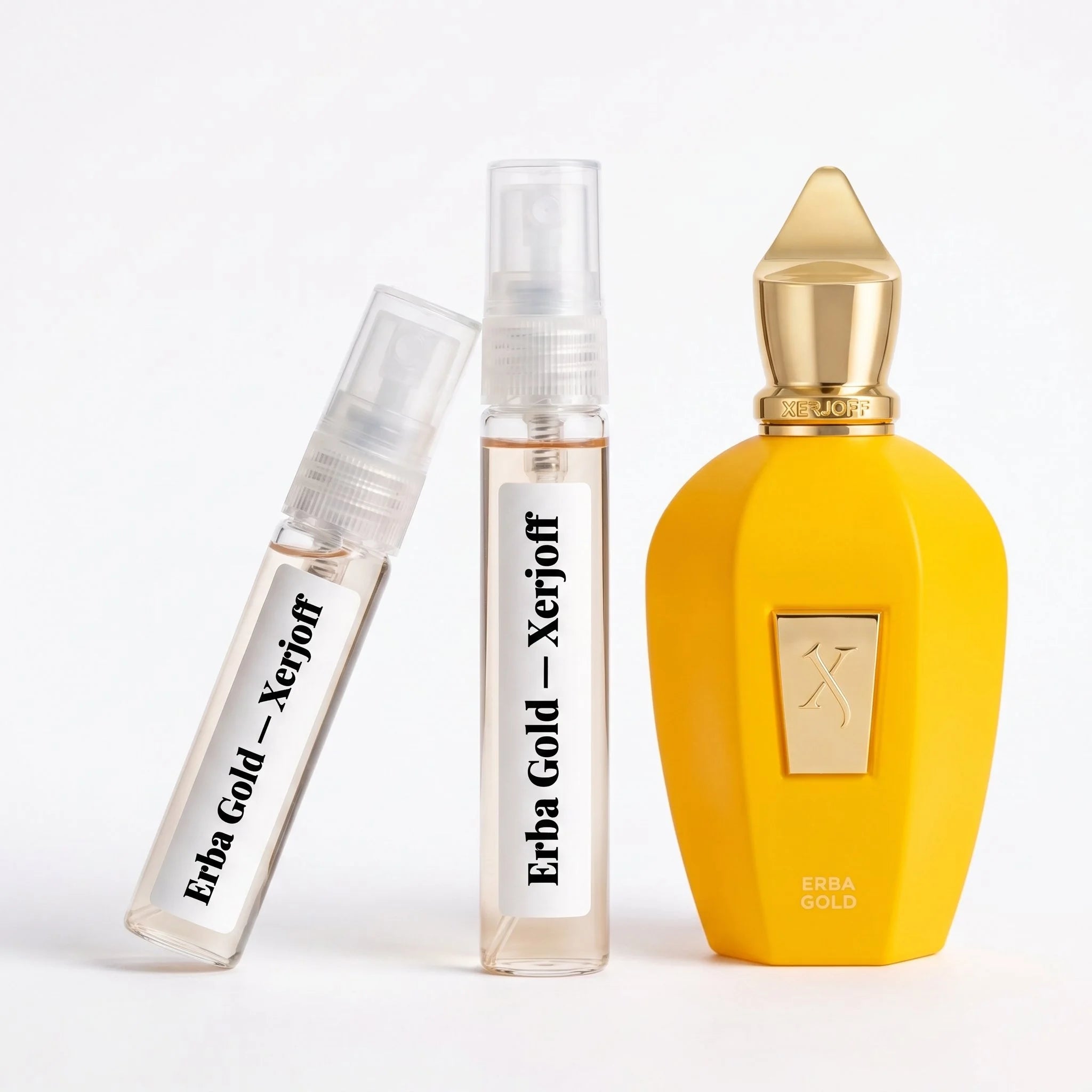 Xerjoff Erba Gold decant vials with vivid yellow bottle on white background luxury niche fragrance photography