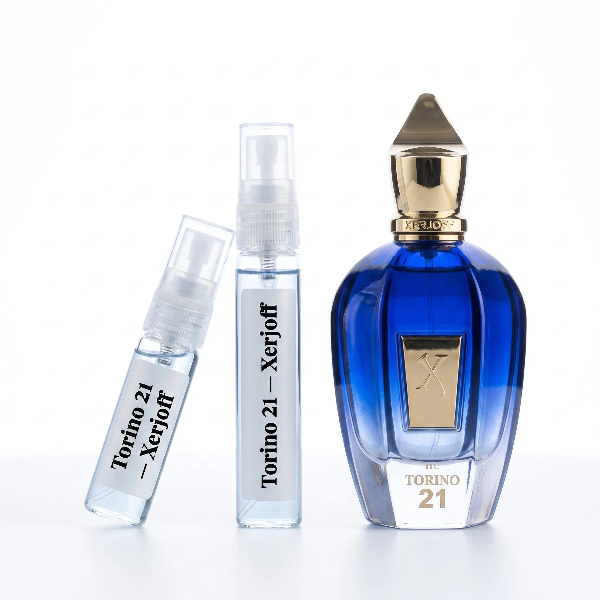 Xerjoff Torino 21 decant vials with sapphire blue bottle on white background luxury niche fragrance photography