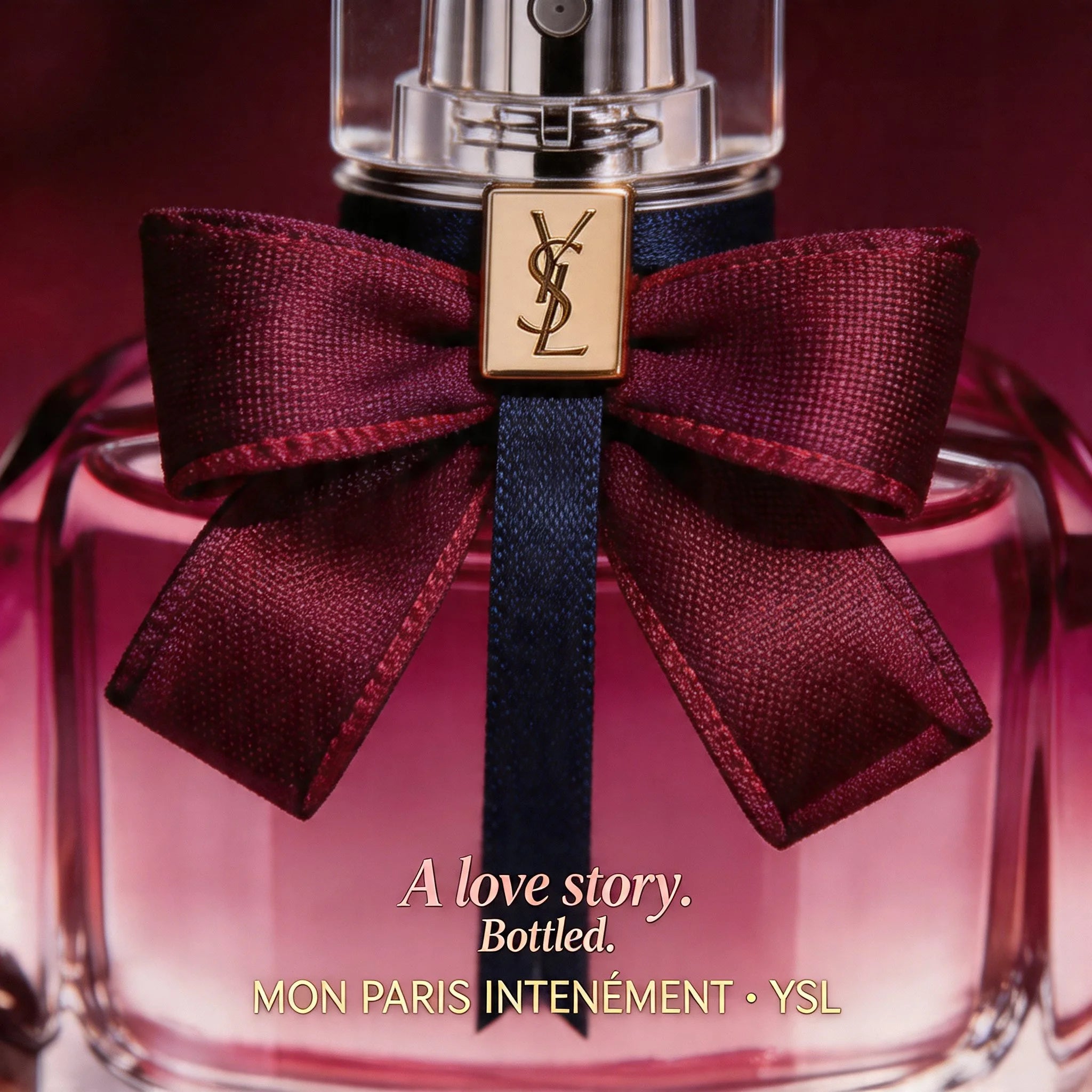 YSL perfume bottle with a red bow on a dark background