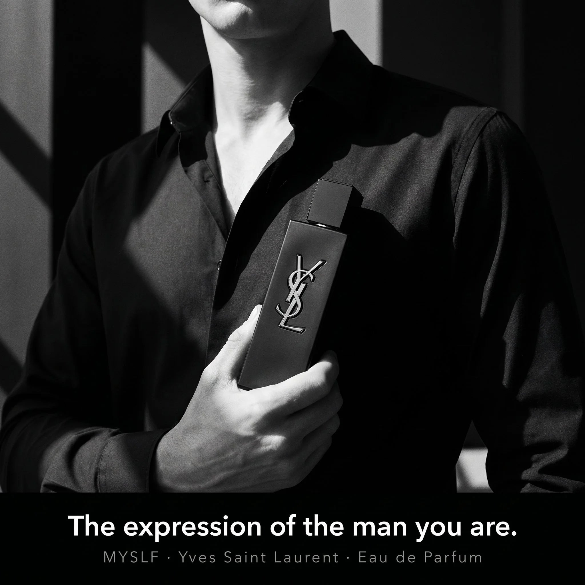 Person holding a YSL perfume bottle with text 'The expression of the man you are.'