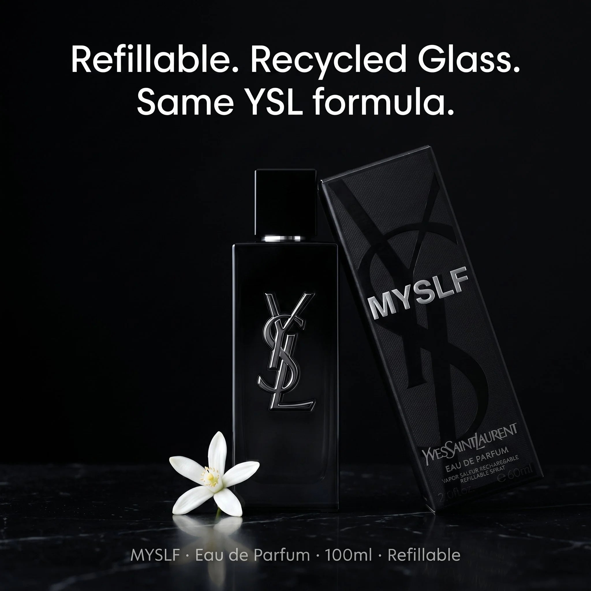 YSL perfume bottle with packaging on a black background