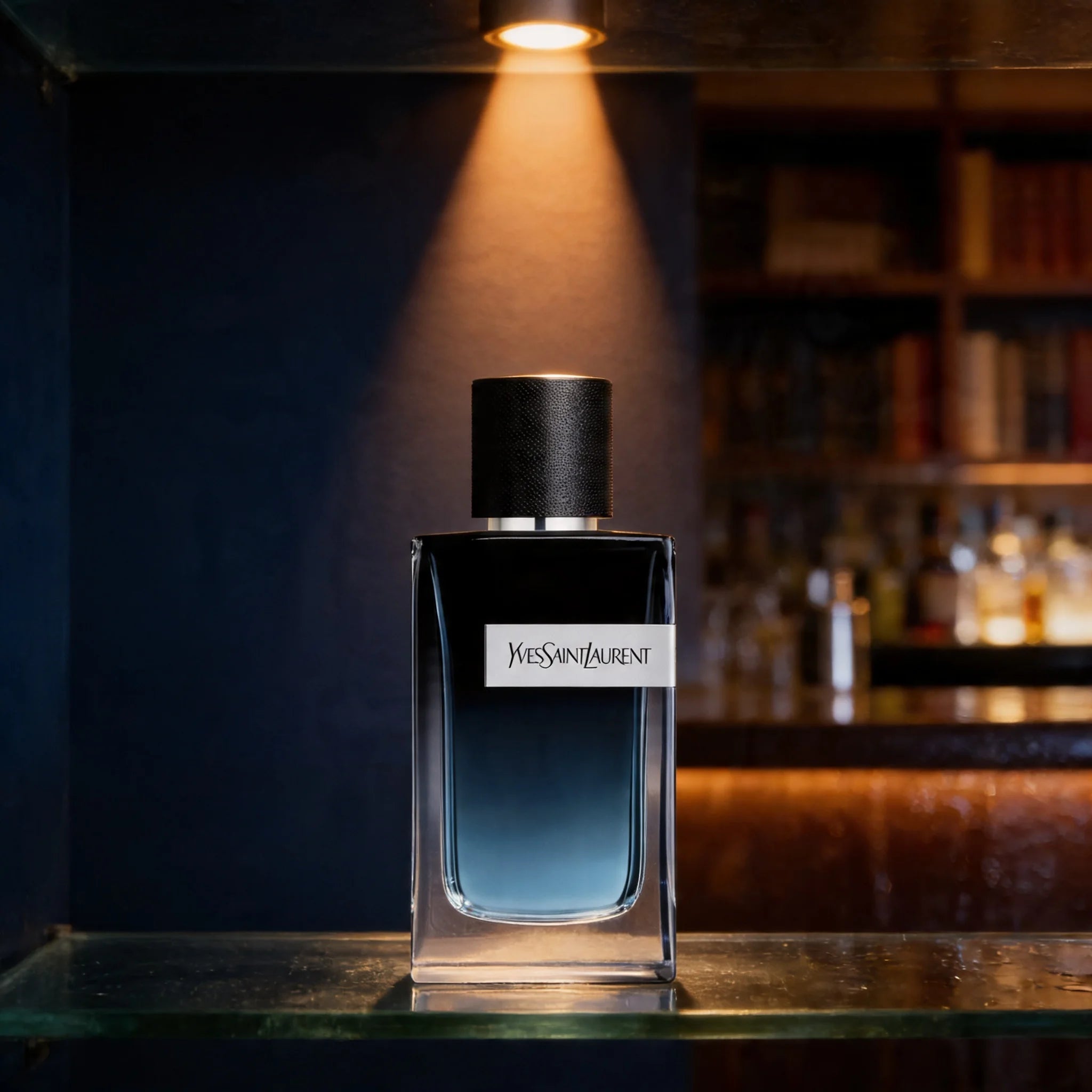 Yves Saint Laurent perfume bottle on a bar counter with a dark background