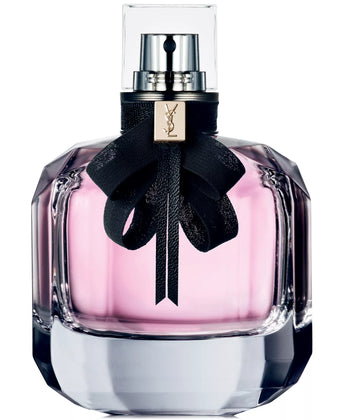 YSL perfume bottle with pink liquid and black ribbon on a white background